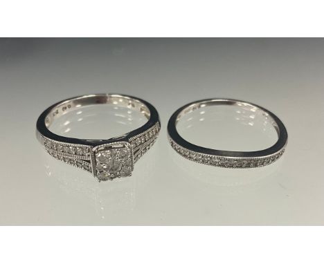 A diamond engagement ring and conforming half eternity ring, set with total of fifty five round brilliant cut diamonds, total