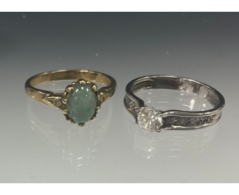 Rings - a diamond and pale green cabochon jade ring, the oval cabochon measuring approx 8mm x 3mm, between brilliant cut diam