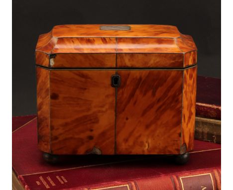 A George III tortoiseshell tea caddy, canted rectangular form, silver wire detailing, twin lidded compartments, raised on bal