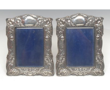 A pair of Art Nouveau period silver easel photograph frames, the crestings with a oval cartouches engraved with initials, bev