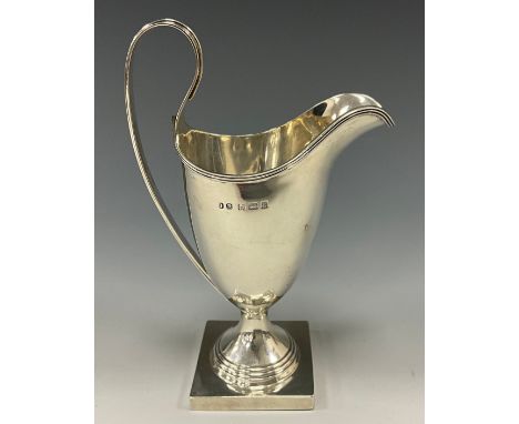 An Edwardian silver helmet shaped cream jug, reeded scroll handle, stepped circular foot, square base, 14cm high overall, Bir
