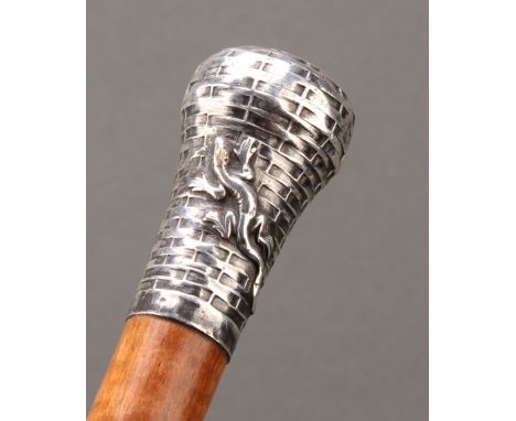 A 19th/20th century walking stick or cane, the silver metal pommel cast with a salamander, indistinctly hallmarked, probably 