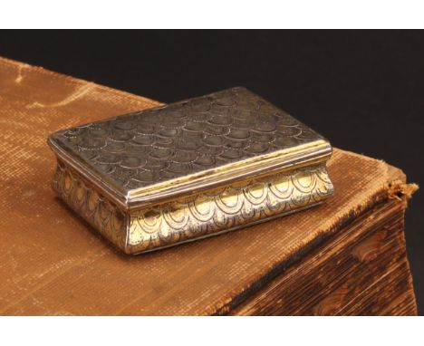 An 18th century Continental silver-gilt waisted rectangular snuff box, chased overall with 'snake skin' scales, hinged cover,