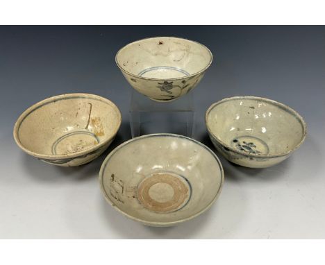 A Chinese blue and white rice bowl, possibly Kangxi period, painted to the exterior with blossoms amidst leafy stems and bamb