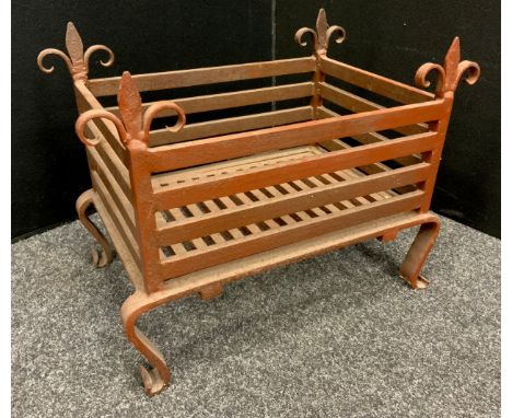 Architectural Salvage - an early 19th century cast iron fire basket, fluer-de-lis finials, cabriole shaped legs with scroll f