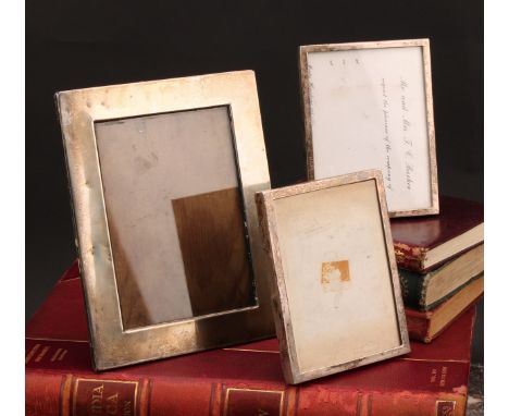 An Edwardian silver rectangular easel photograph frame, quite plain, 18cm high, Henry Matthews, Birmingham 1908; others (3)