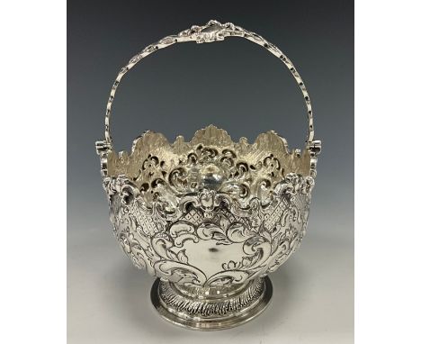 A Victorian silver swing handled sugar bowl, deeply embossed with acanthus, scrolls and scaled motifs, Goldsmiths &amp; Silve