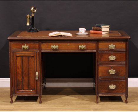 An Edwardian mahogany twin pedestal desk, rounded rectangular top with moulded edge and inset writing surface above an arrang