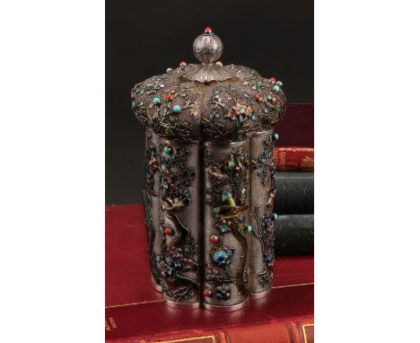 A Chinese silver and enamel lobed cylindrical pagoda shaped tea caddy, double-walled and applied on a filigree ground with bi