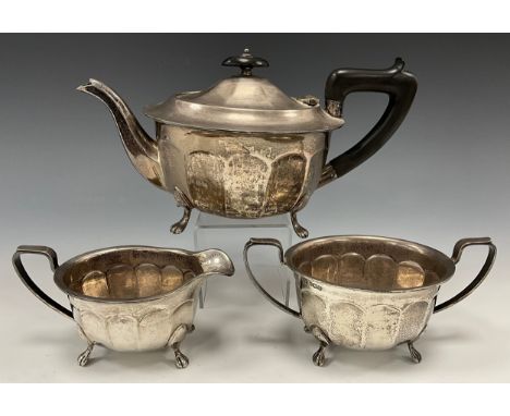 A George VI silver three piece tea set, comprising ebony handled teapot, milk jug and sugar bowl,  Viners Ltd, Sheffield 1946