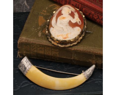 A Victorian cameo brooch carved with Artemis amongst clouds beneath a scarf crest, unmarked yellow metal mount, 5.6cm x 4.5cm