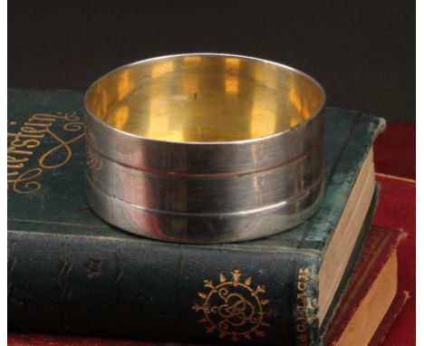 An Irish provincial silver circular salt, the side with faux-coopered bands, gilt interior, 6.5cm diam, John Toleken, Cork, c