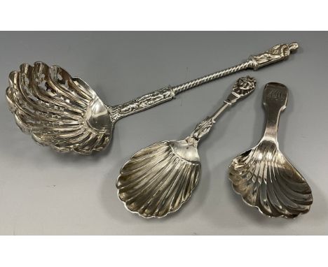 A George III shell bowl caddy spoon, William Eaton, London 1818; another, Victorian, London 1878; a straining spoon, Henry Jo