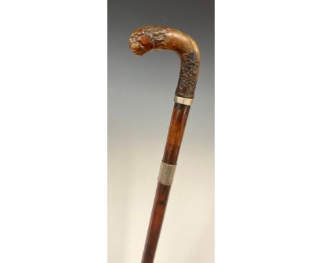 A George V walking stick, the horn handle carved with a lion head and terminating with a floral arrangement in the Art Nouvea