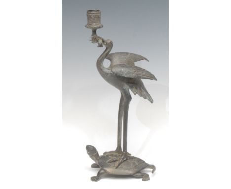 A 19th century dark patinated bronze candlestick, after Antoine-Louis Barye (1795-1875), as a stork standing on a turtle's ba