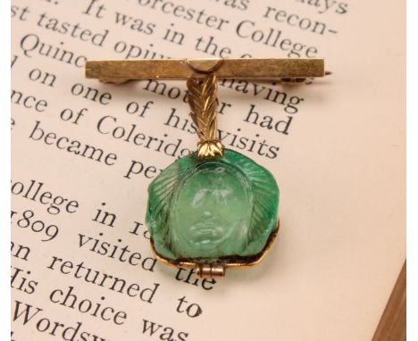 Alfred Lyndhurst Pocock (1882 - 1962), an 18ct gold mounted emerald intaglio brooch, carved as the face of a beauty, 2.5cm ov