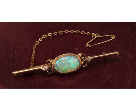 A 9ct gold bar brooch, set with a single polished oval opal cabochon, the stone 14mm, marked 9ct, safety chain, 6cm overall, 