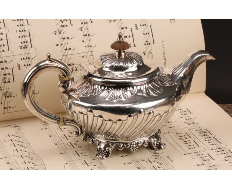 A William IV silver teapot, embossed collar and sides, scrolled handle, floral frieze, John Fry II, London 1835, 18.3ozt gros