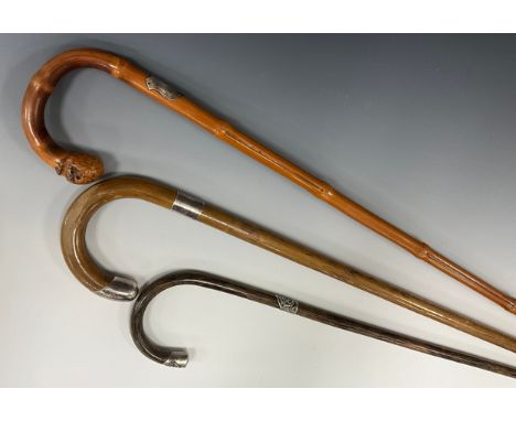 A George V walking stick, silver mounted handle terminus, silver collar, malacca cane, 85cm long overall, London 1911; anothe