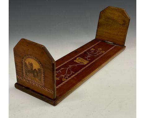 An Irish Killarney marquetry book slide, inlaid with a harp and a view of Muckross Abbey, inscribed Killarney Lakes, 45cm wid