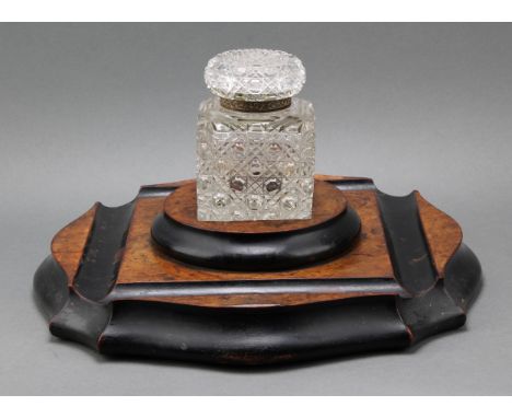 An unusually large Victorian burr walnut and ebonised serpentine inkstand, the square hobnail-cut inkwell with hinged cover, 