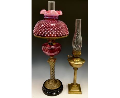 A Victorian cranberry and opaline glass oil lamp, Fenton hobnail wavy top shade,  25.5cm diameter, above cranberry reservoir,