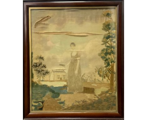 A George III embroidered silk crewelwork and painted portrait, of a Lady Holding a Book, Building in the Distance, 54cm x 45c