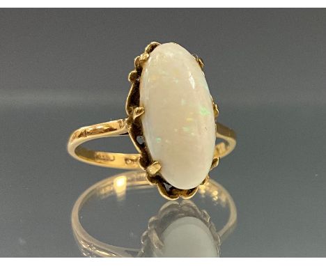 A cabochon opal ring, approx 14mm x 7mm opal flashing blue, green and red play, 9ct gold shank, size P/Q, 2.8g gross