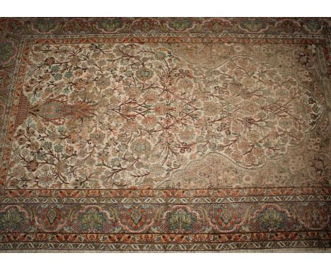 A Middle Eastern woven silk rectangular rug or carpet, the field worked with the Tree of Life beneath inscription, in tones o