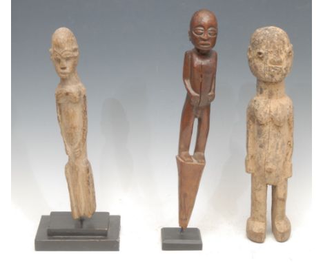 Tribal Art - a Lobi figure, 33cm high, Burkina Faso; another, 29cm high, collector's display stand; another (3)