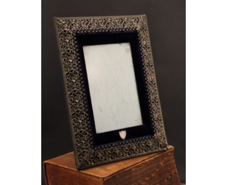 A large Victorian E.P.N.S mounted easel photograph frame, the pierced border embossed with scrolling leaves, 40cm high, c.189