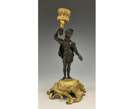 A 19th century Continental patinated bronze and ormolu figural candlestick, as a young man in Renaissance dress, campana scon