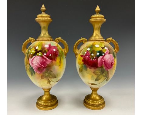 A pair of Royal Worcester twin handled vases with covers decorated with roses and gilt detail, painted by A. Watkins, puce ma