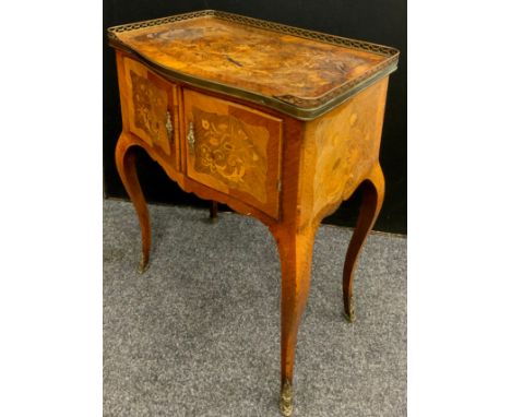 A Louis XV Revival walnut and marquetry inlaid side cabinet, brass galleried overhanging top above two inlaid doors enclosing