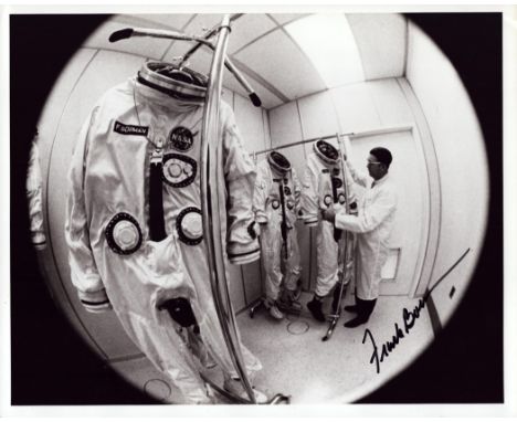 Frank Borman signed 10x8 inch vintage black and white photo picturing the crew's space suits. From single vendor Space Astron