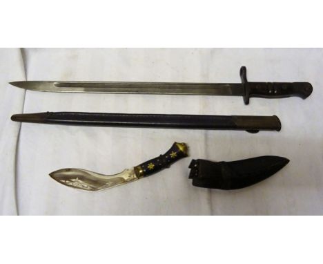 A WWI Bayonet and Scabbard and a small Kukhri and skinning knives in scabbard.