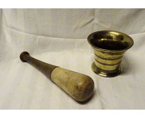 An early 19th Century brass Mortar, together with a ceramic and wood pestle. 