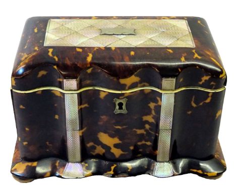 A mid 19th Century tortoise shell Tea Caddy of serpentine outline, the hinged lid inlaid with a mother of pearl panel and fur