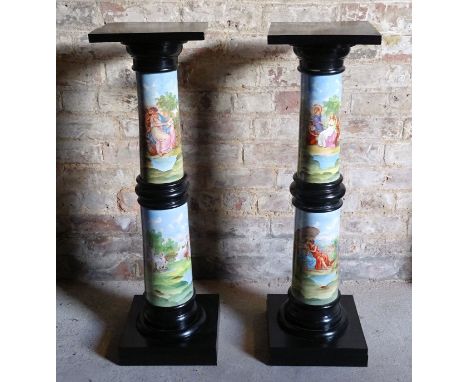 A pair of ebonised Pedestals, the ceramic columns decorated with scenes of classical figures and landscapes and on square bas