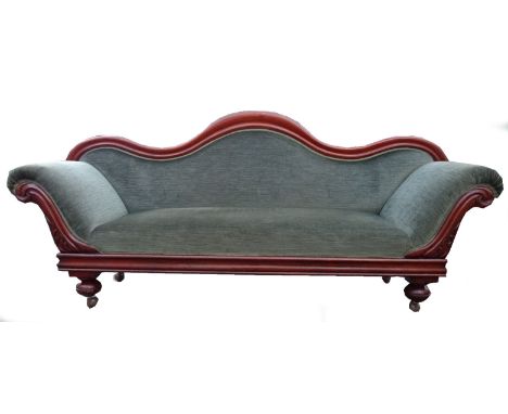A Victorian mahogany frame camel back Sofa with upholstered seat and back carved rails and bun feet.  7' (214cms) wide. 