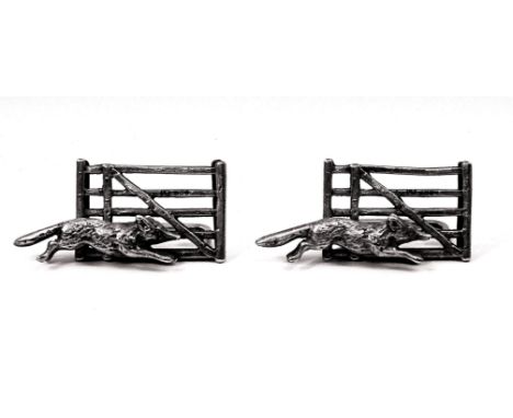 A pair of silver Place card Holders in the form of a fox running in front of a five bar gate.  Birmingham 1928, maker Lawrenc