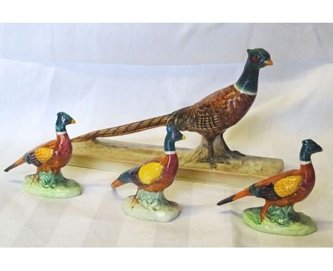 A Beswick model of a Pheasant on a ceramic base, no. 1774, a pheasant ornament, no. 767a and two others 767b.