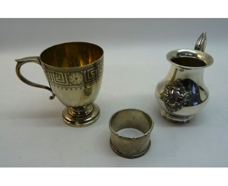 A Victorian silver Christening Cup with gilded interior and key pattern decoration on a pedestal foot and with loop handle. L