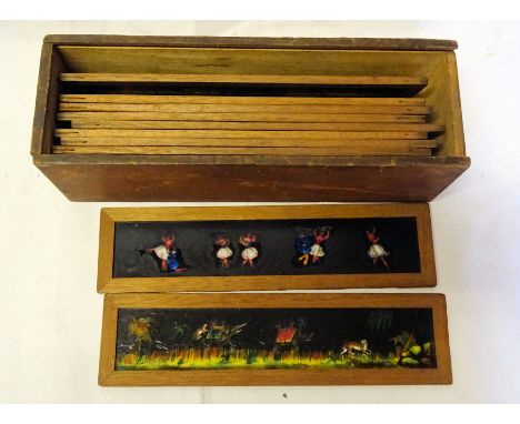 A wooden box containing framed coloured Magic lantern Slides and various loose slides. 
