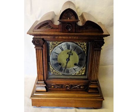 An early 20th Century Mantle Clock with steel and brass dial, gong strike and in architectural style walnut case.  16" (41cms