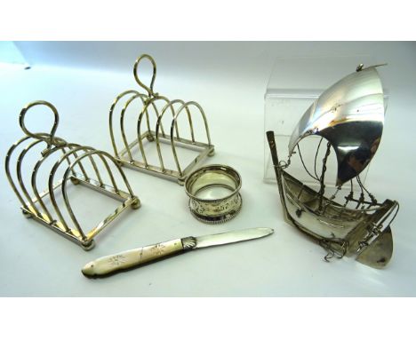 A pair of late Victorian silver, four division, Toast Racks, Sheffield, 1900, 925 standard model boat, silver serviette ring 