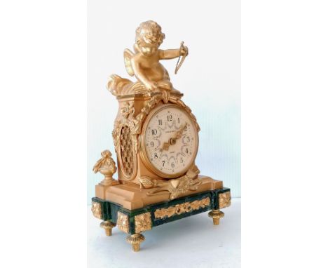 A 20th century Charles Beyfus of London ormolu and jade mantle clock in the Louis XVI style, surmounted by Cupid and garlands