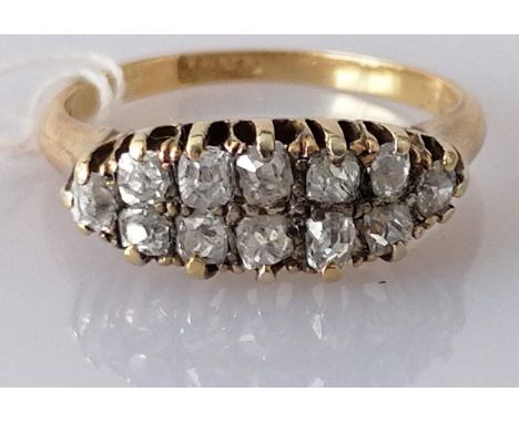 A Victorian two-row diamond cluster ring claw-set on a yellow gold setting, the twelve old-cut diamonds weighing approximatel