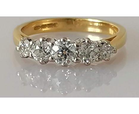 A modern five-stone graduated diamond ring on a yellow gold setting, with three graduated old-cut diamonds flanked by a round