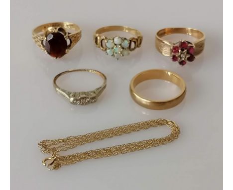 Four gem-set gold rings, including a single-stone garnet ring, a ruby and diamond cluster ring, an opal cluster ring, a three